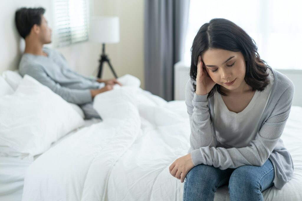 Asian young girl feel angry boyfriend having conflict domestic problem in bedroom.