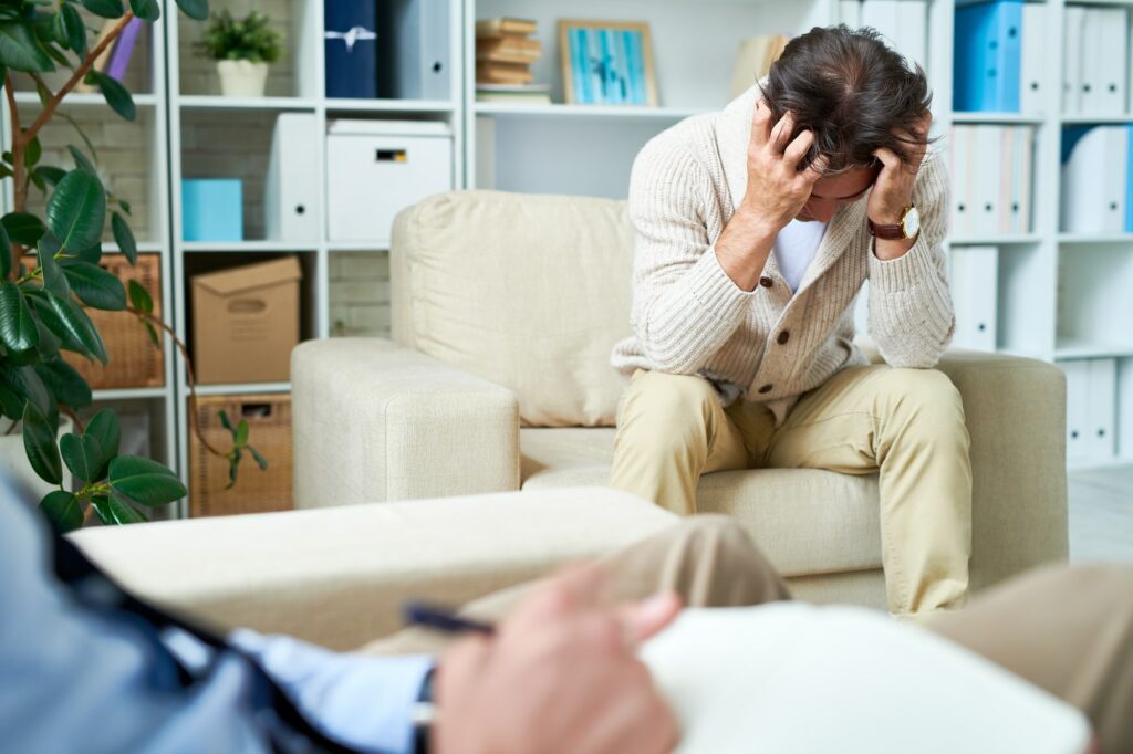Depressed man at psychotherapy session